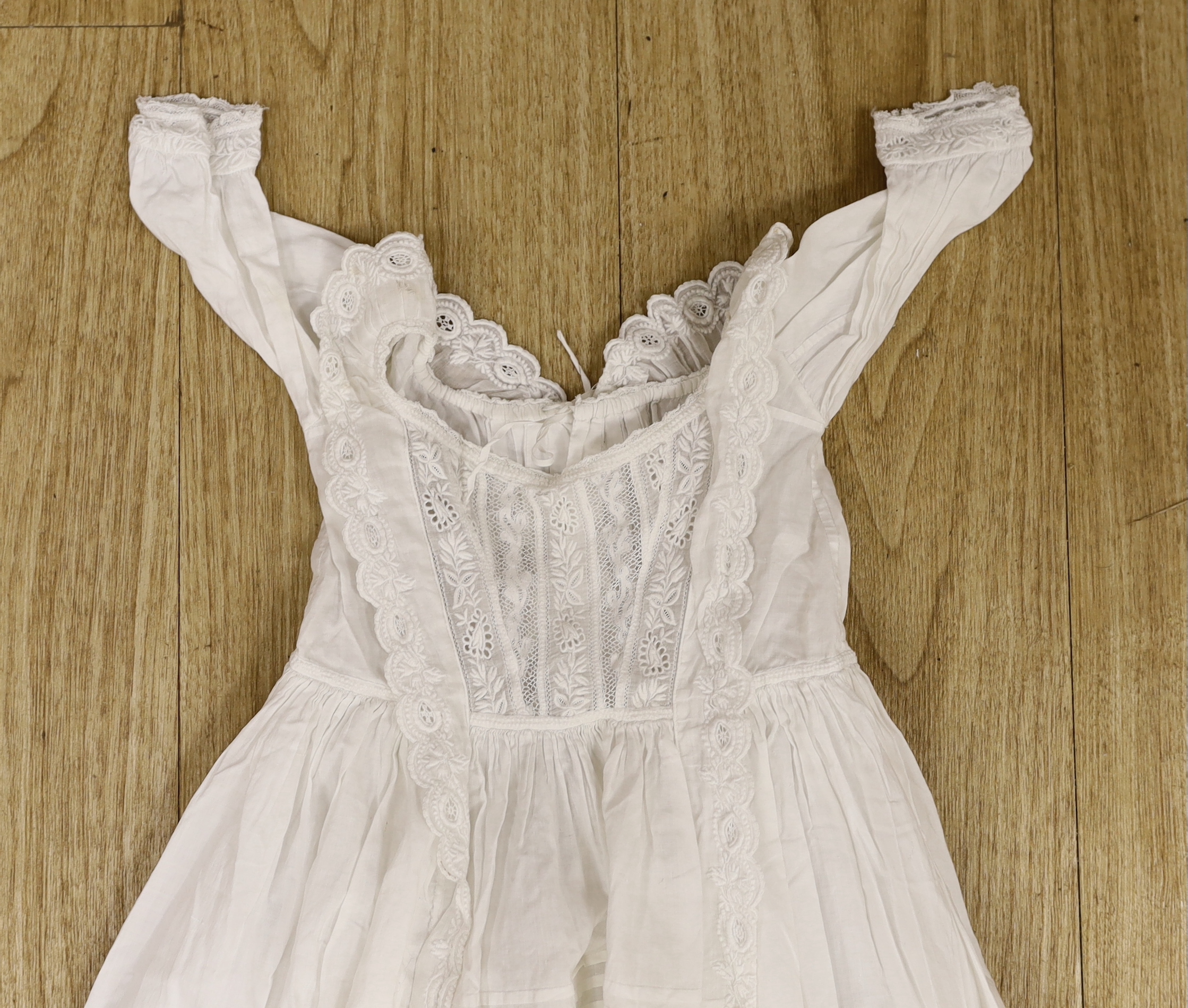 Five 19th century white worked and embroidery anglaise christening gowns, six similar baby dresses a cream wool silk embroidered shawl and a knitted shawl etc